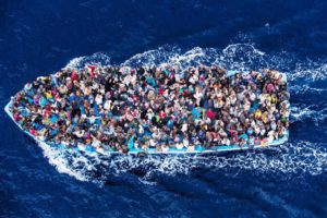 4/Hundreds of refugees and migrants aboard a fishing boat are pictured moments before being rescued by the Italian Navy as part of their Mare Nostrum operation in June 2014. Among recent and highly visible consequences of conflicts around the world, and the suffering they have caused, has been a dramatic growth in the number of refugees seeking safety by undertaking dangerous sea journeys, including on the Mediterranean. The Italian Coastguard / Massimo Sestini